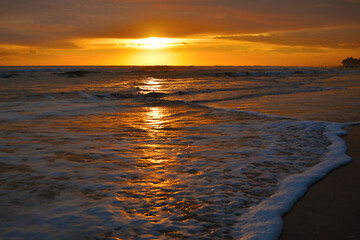 Beautiful sunset beach with wave
