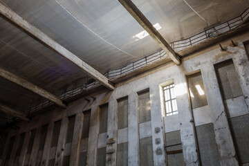 Interior and low angle view of windows on the top of wall and hallway of abandoned industrial building in Berlin, Germany. 