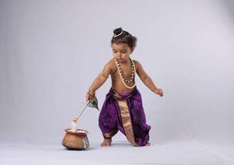 Janmashtami concept- adorable Indian baby in krishna kanha or kanhaiya dress posing with his flute...