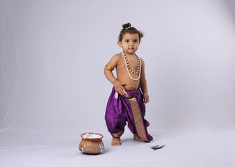 Janmashtami concept- adorable Indian baby in krishna kanha or kanhaiya dress posing with his flute...