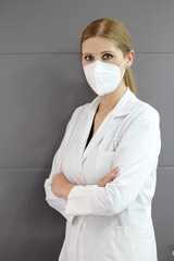 Female neurologist doctor reviewing head tomography and working with mask in hospital
