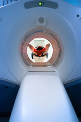 patient entering an MRI machine to produce a detailed and internal image of their organs to...