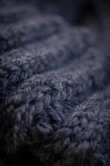 Close-up of the texture of a handmade knitted sweater. Rows of loops.