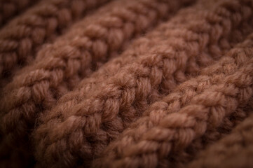 Close-up of the texture of a handmade knitted sweater. Rows of loops.