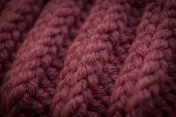 Close-up of the texture of a handmade knitted sweater. Rows of loops.