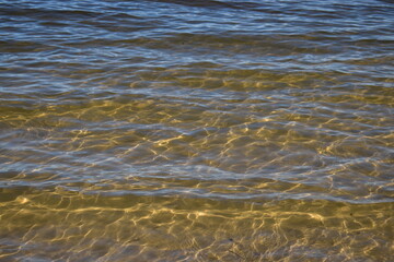 sunlight diffraction patterns in shallow water at a low energy coastline