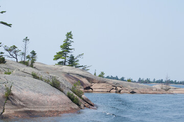 Smooth granite rocks and windswept pines in Indian Harbour Georgian Bay Ontario Canada