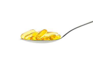 Gold fish oil on spoon on white background.