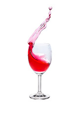 Red wine splash into glass on white background.