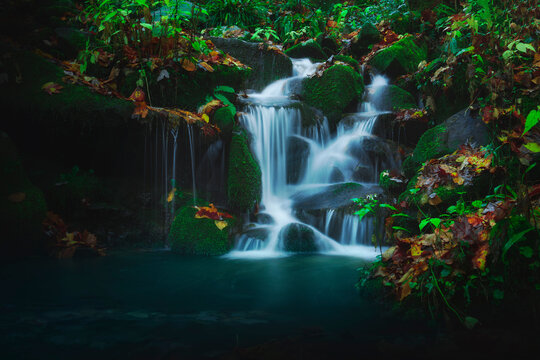 Beautiful Slow Waterfall Photograph In Deep Lush Green Wooded Forest Jungle