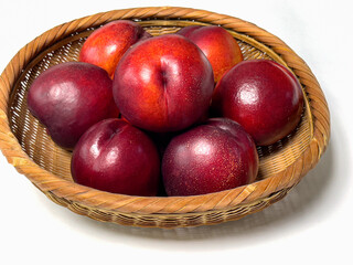 Sweet red nectarines in a bamboo basket