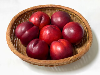 Sweet red nectarines in a bamboo basket