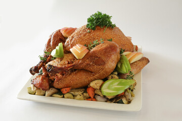 bbq roasted marinated whole big turkey with mixed vegetables in white background Christmas festival menu