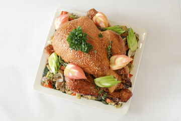 bbq roasted marinated whole big turkey with mixed vegetables in white background Christmas festival menu