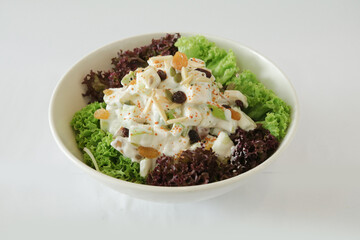 season green vegetables, potato and fruit apple coleslaw with salad dressing sauce appetiser in white background Christmas festival menu