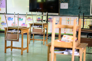 School empty classroom, Lecture room with desks and chairs iron wood for studying thailand without young student.School closed due to covid 2019