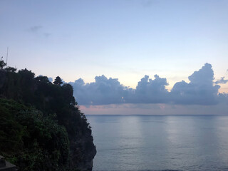 Sunset from the Pura Uluwatu temple on Bali island in Indonesia. - stock photo