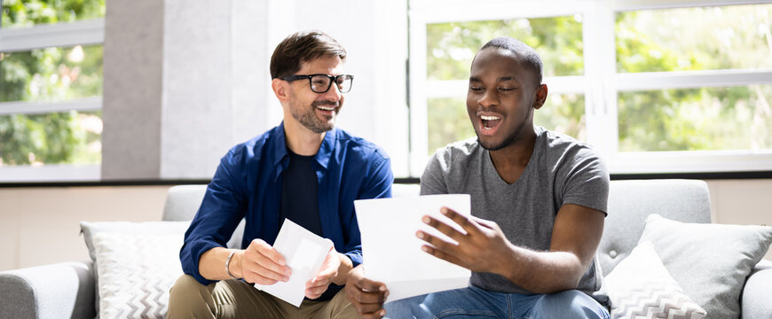 Happy Gay Couple Reading Letter