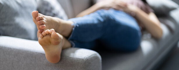 Stinky Feet Resting On Couch. Foot Smell - obrazy, fototapety, plakaty