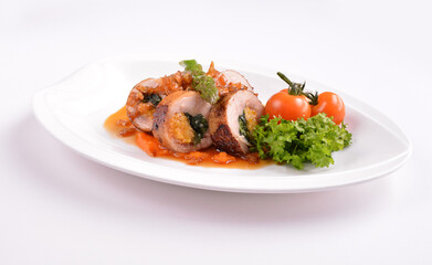 grilled chicken meat wrapped with pumpkin and vegetables roll with tomato sauces in white background for Christmas festival menu