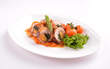 grilled chicken meat wrapped with pumpkin and vegetables roll with tomato sauces in white background for Christmas festival menu