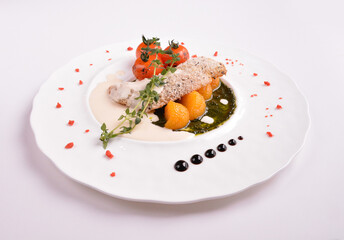 deep fried bake bread fish fillet seafood with orange and tomato in chef rosemary sauce and vegetables in white background for Christmas festival menu