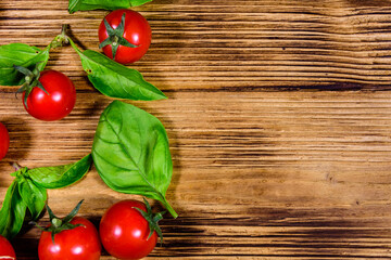Heap of small cherry tomatoes on wooden table. Top view