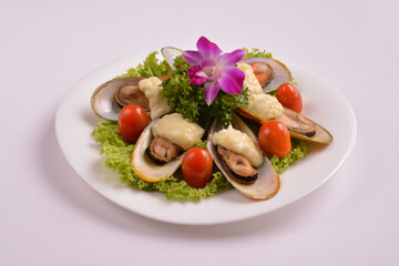 bbq baked cheese muscle on shell seafood with vegetable salad in white background for Christmas festival menu