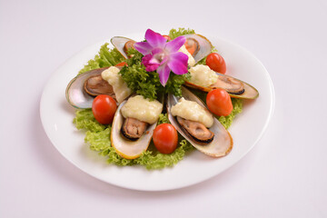 bbq baked cheese muscle on shell seafood with vegetable salad in white background for Christmas festival menu
