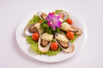 bbq baked cheese muscle on shell seafood with vegetable salad in white background for Christmas festival menu