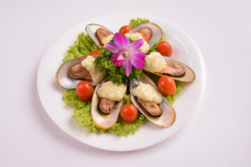 bbq baked cheese muscle on shell seafood with vegetable salad in white background for Christmas festival menu