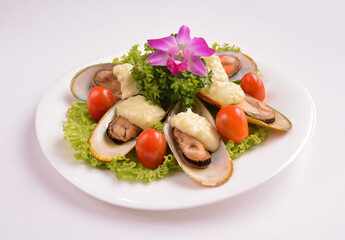 bbq baked cheese muscle on shell seafood with vegetable salad in white background for Christmas festival menu