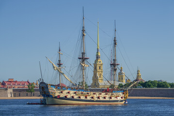 Russian old battleship Poltava against the backdrop of Peter and Paul Cathedral on July sunny...