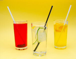 A set of summer refreshing cocktails with ice on a light background
