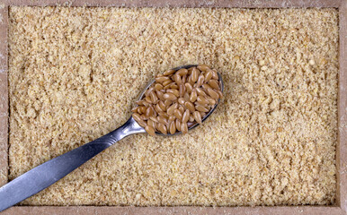 top view of flour golden flaxseeds or golden linseed (Linum usitatissimum) in a rectangular wooden...