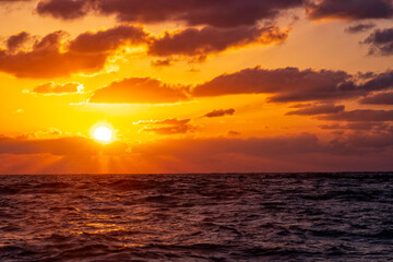 Sunset on the Mediterranean Sea. Dramatic sky in the clouds. The reflection of the sun on the waves