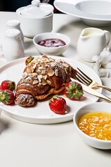 Crispy Croissants with fresh strawberries and sweet berry jam. Delicious continental breakfast. Appetizing Sweet food. Light background. French pastry. Elegant serving. Vertical shot. Copy space