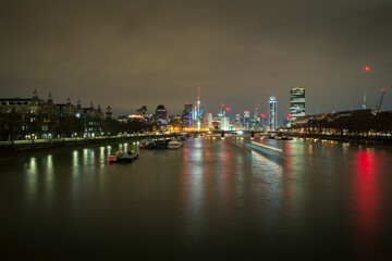 Fototapeta na wymiar A long exposure photo of Thames river at night in London, UK