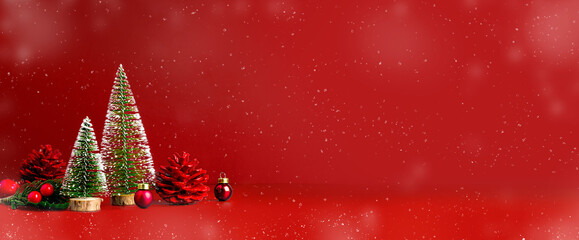 Merry Christmas and happy new year snow falling  red background with xmas tree and pine cone...