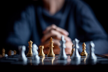 young child playing chess board game for strategy and intelligance game concept. 