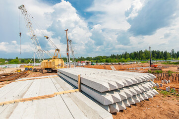 piles lie on the construction site in the summer
