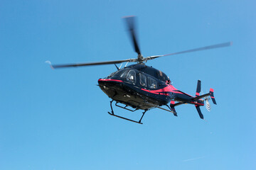 Black commercial helicopter in flight