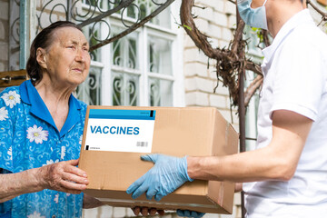 Vaccinated covid-19 stamp printed on cardboard box. Virus epidemic, vaccine against COVID-19,...
