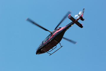 Black commercial helicopter in flight