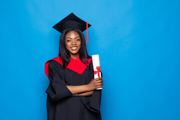 Beautiful african woman wearing a blue graduation gown holding a diploma and very happy and excited...