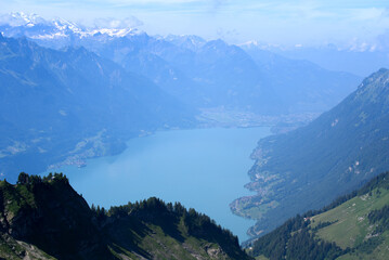 Aerial view of Lake Brienz at Bernese Highland with beautiful mountain panorama on a sunny summer morning seen from steam train. Photo taken July 21th, 2021, Flühli, Switzerland.
