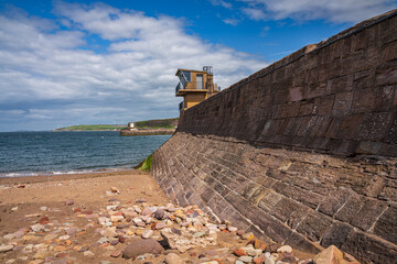 Fototapeta na wymiar The Old Quay with the North Pier Lighthouse in the background, seen in Whitehaven, Cumbria, England, UK