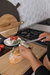 Woman's hands preparing bread and snack in luxury kitchen 