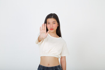 Young serious beautiful woman showing stop sign