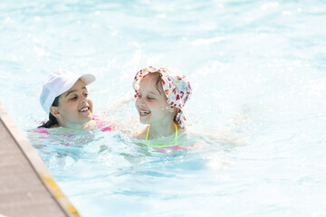 Happy child playing in swimming pool. Summer vacation concept